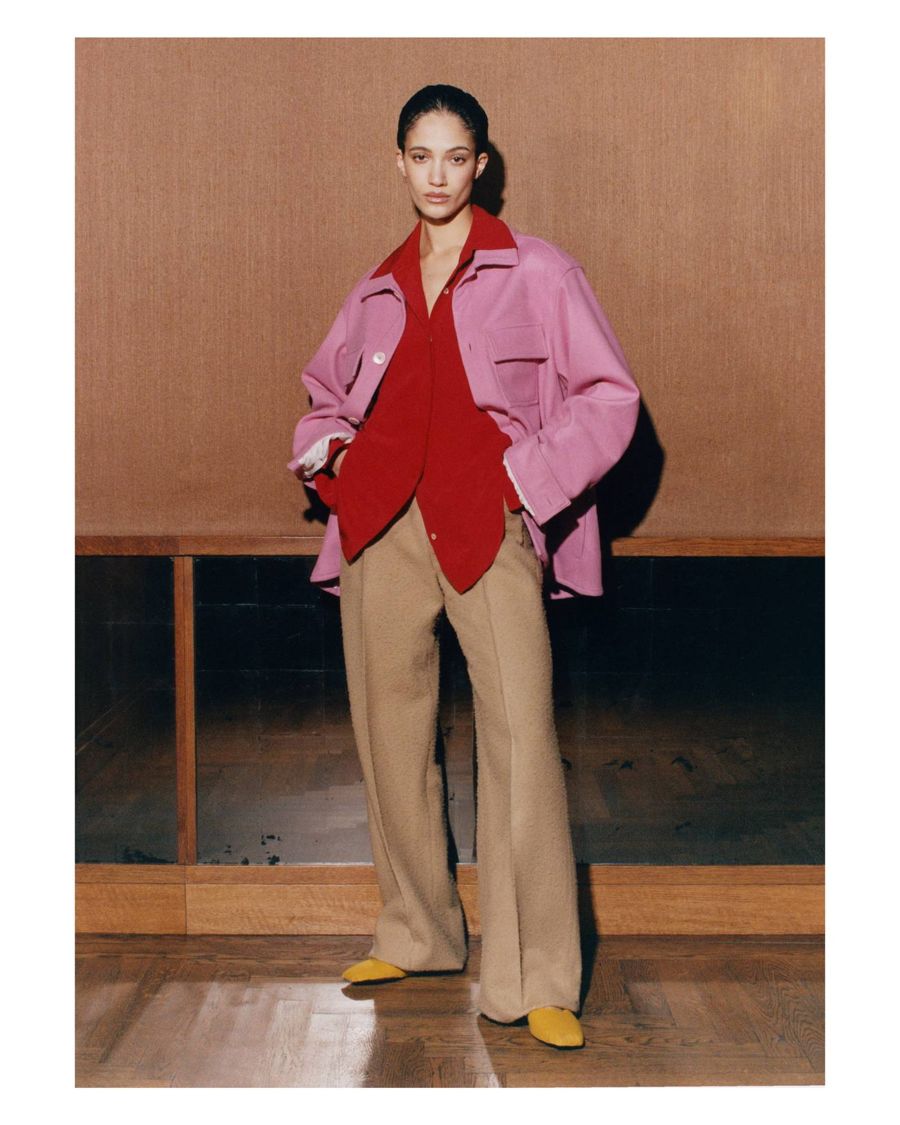 Fashion portrait with slicked-back hair, pink jacket and red shirt
